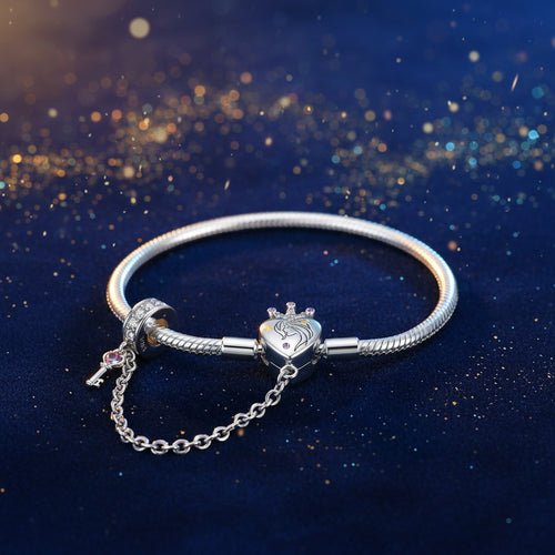 Silver bracelet with heart-shaped clasp and chain on a white background